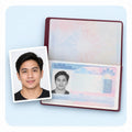 A passport open at a visa sticker, with a finished photo beside it