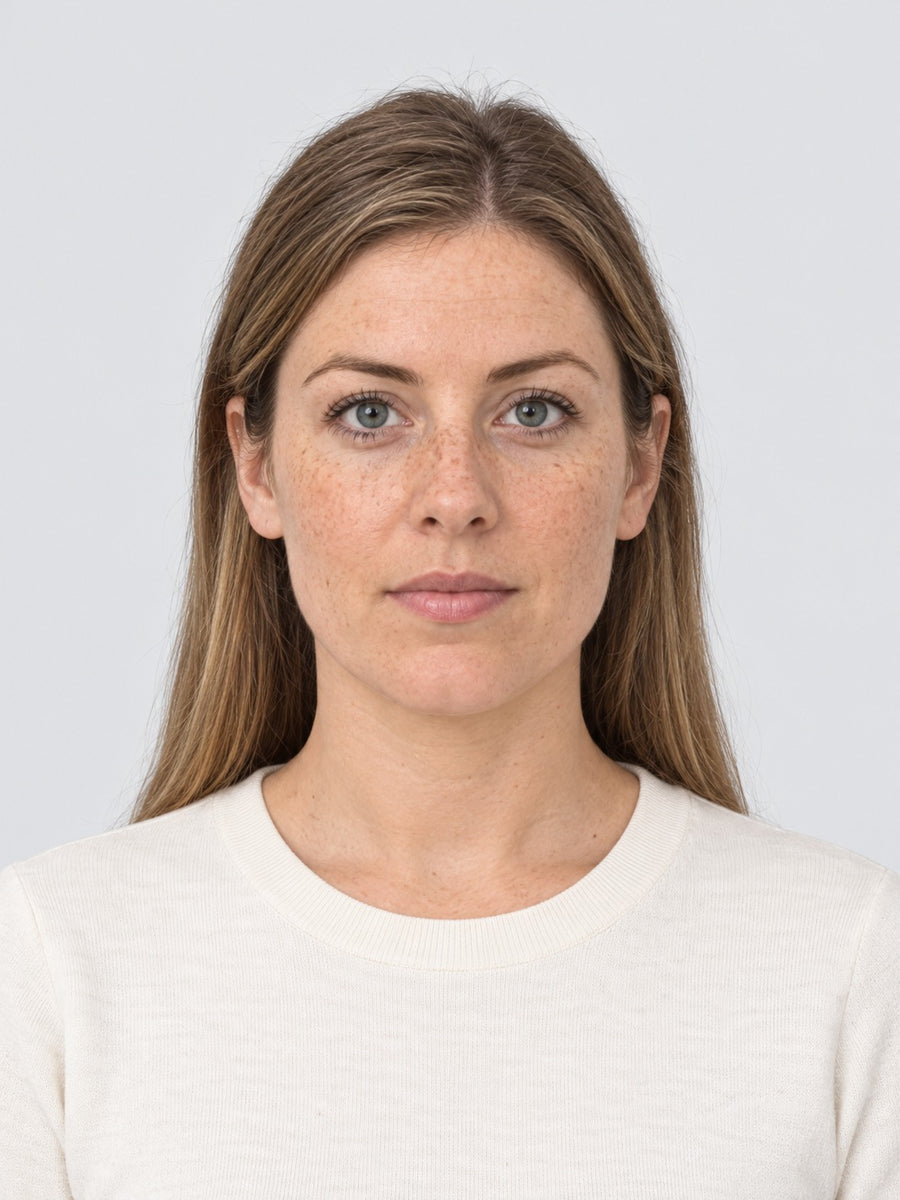 A finished photo of a woman from head to mid torso on a plain light grey background, with its measurements marked