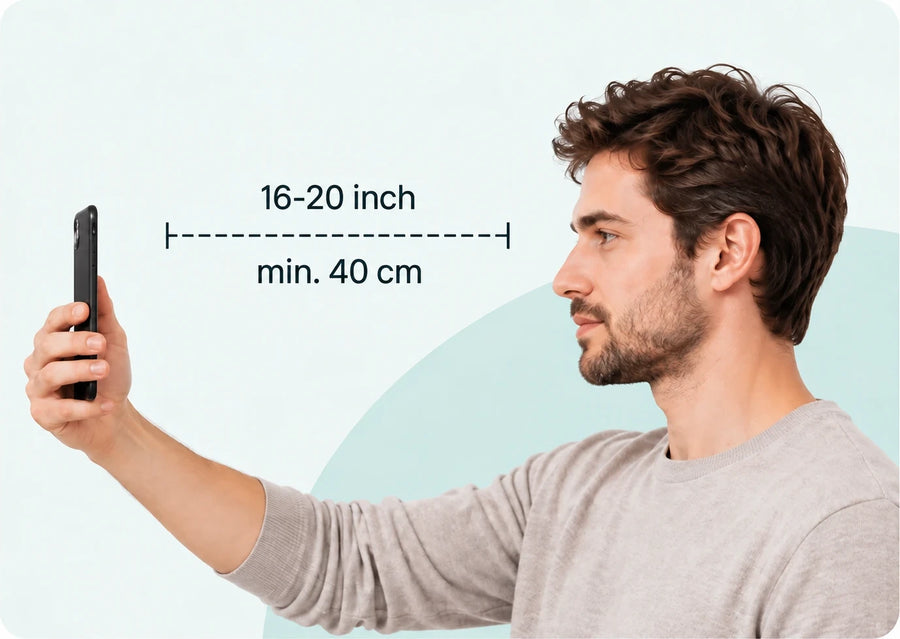 A man holding a phone at arm's length with the distance marked